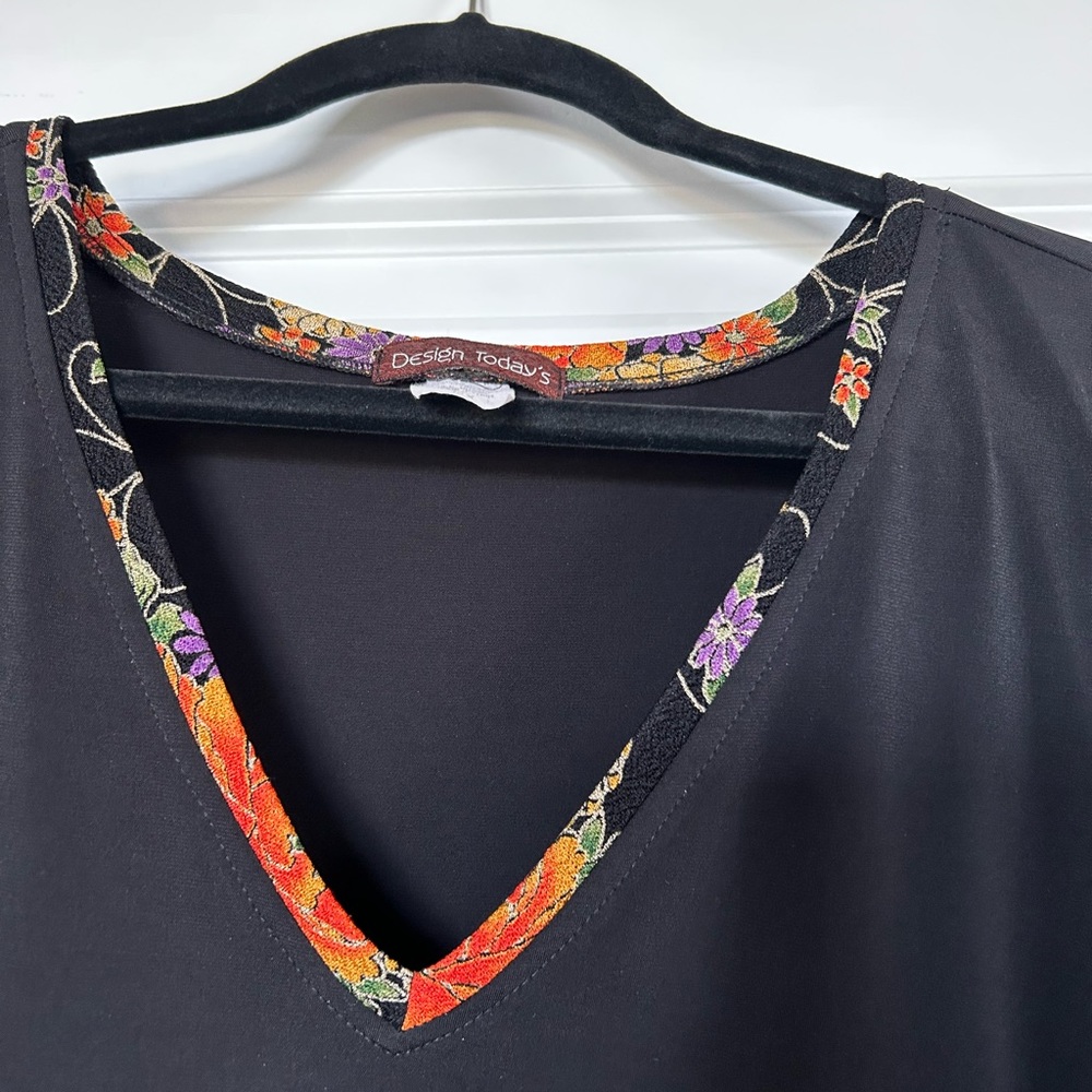 Black top with floral trim. - Picture 4 of 9